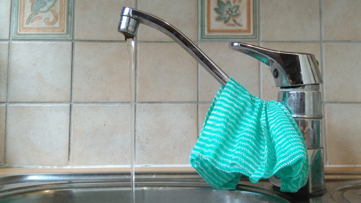 Water running from a kitchen faucet, the household fixture where black water from pipes is usually first noticed