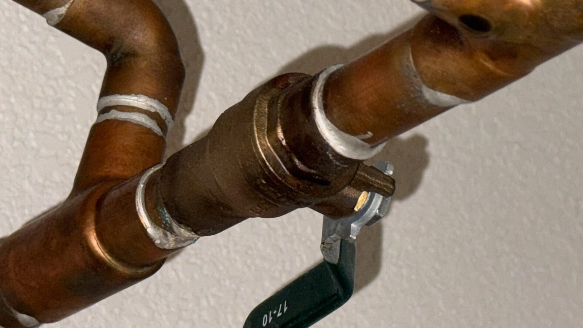A main water shut-off valve on copper pipes, the kind of valve you shut off to stop water flowing into a home